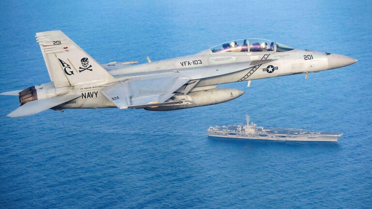 U.S. Navy jet over the Red Sea, highlighting the friendly fire incident with a missile cruiser.