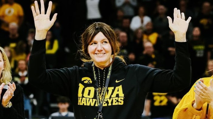 Jamie Cavey-Lang, former Iowa basketball star, smiling on the court during her college career, remembered for her legacy and impact.