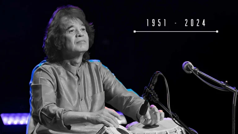 Legendary tabla maestro Zakir Hussain performing on stage.