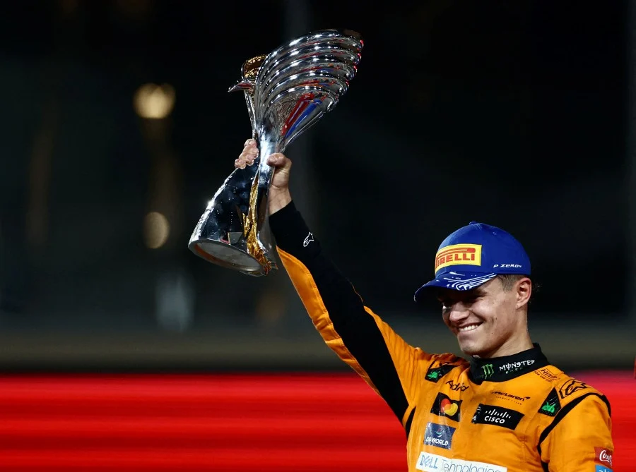 Lando Norris celebrates victory at the 2024 Abu Dhabi Grand Prix, driving his McLaren to secure the team's first Constructors' Championship title since 1998