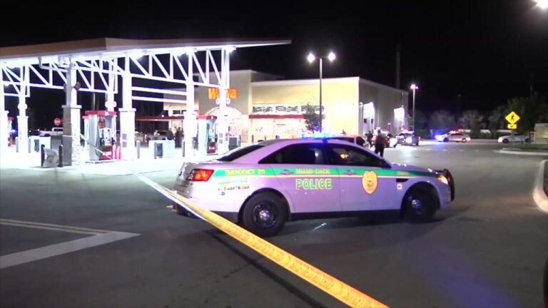 Police cars and caution tape outside a Wawa gas station in Miami-Dade after a tragic shooting left one dead and another injured